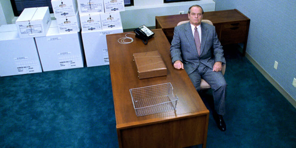 A man looks up from his office desk in About Schmidt.