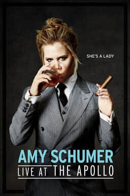 Amy Schumer: Live at the Apollo - Amy Schumer in a grey tuxedo drinking whiskey and smoking a cigar
