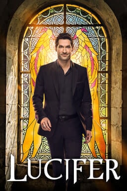 Tom Ellis as Lucifer standing in front of stained glass window